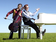 Cello and piano duo in a field with a grand piano